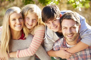 A family of four posing for the camera.